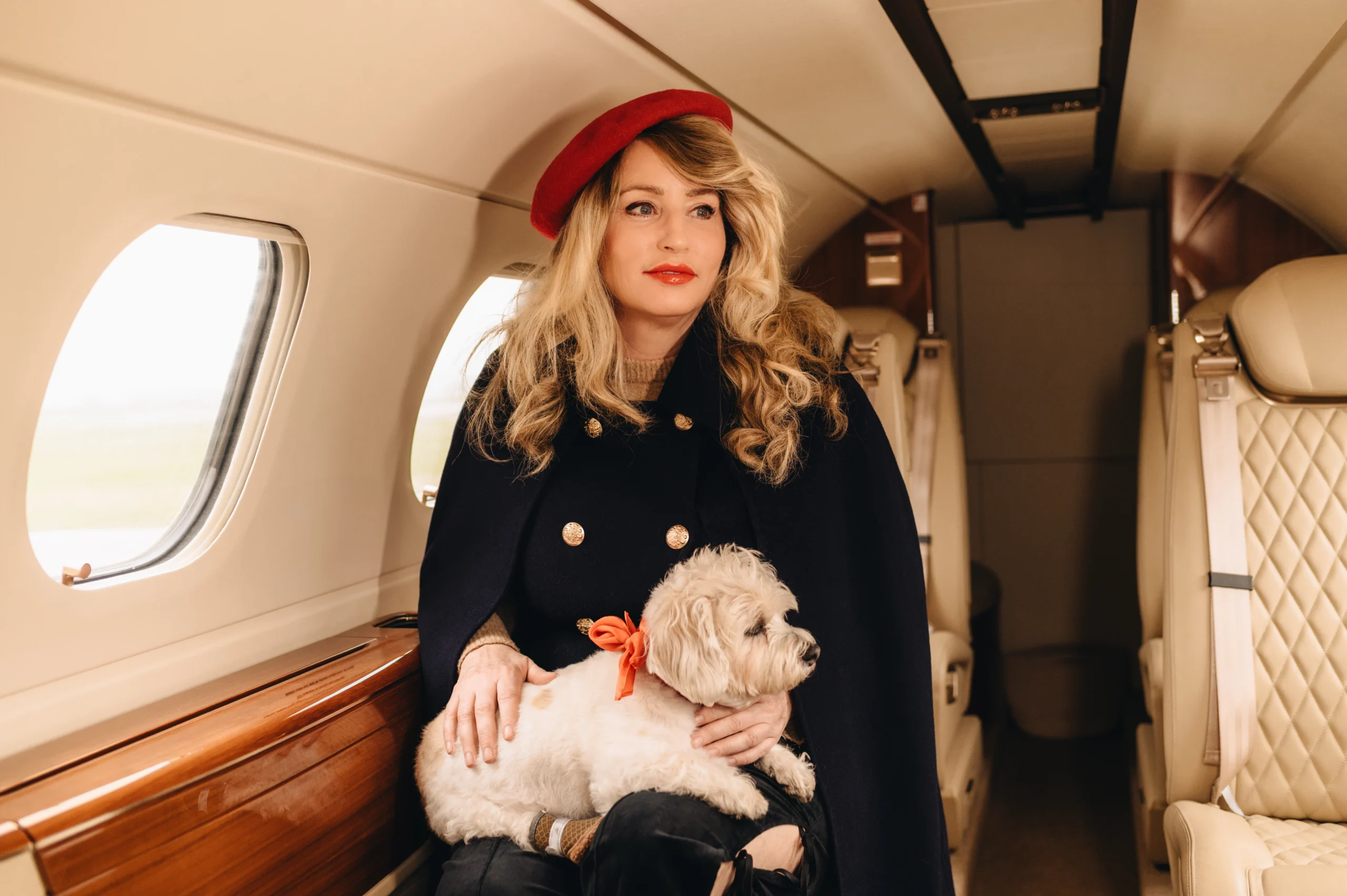 Tuscan Hound Woman with dog sitting inside private jet